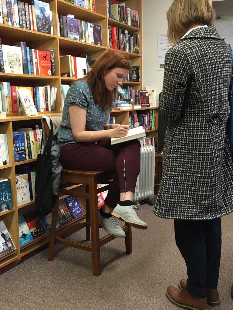 Eleanor signing a copy of her novel